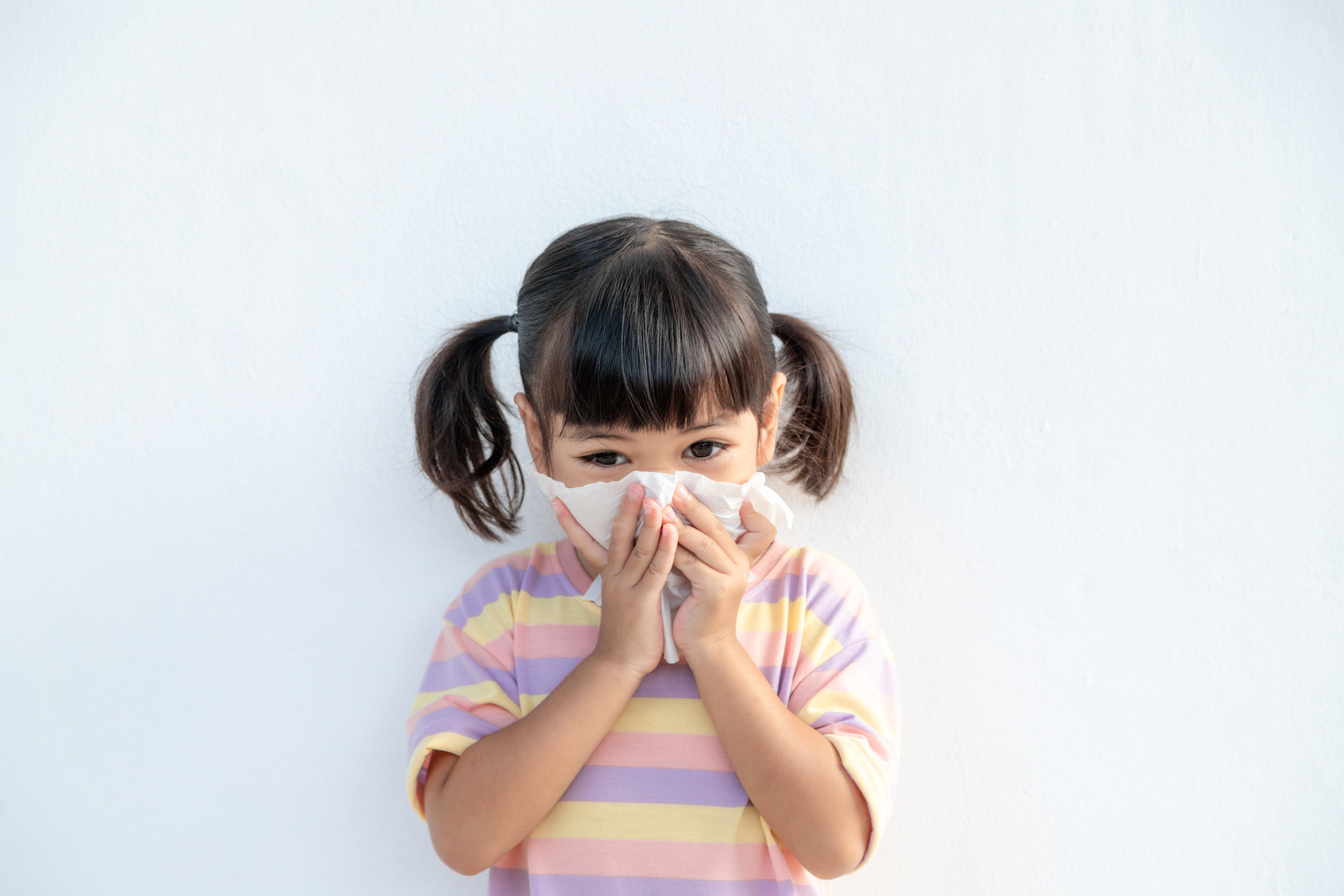 Asian Child Girl Sick with Sneezing on the Nose and Cold Cough O