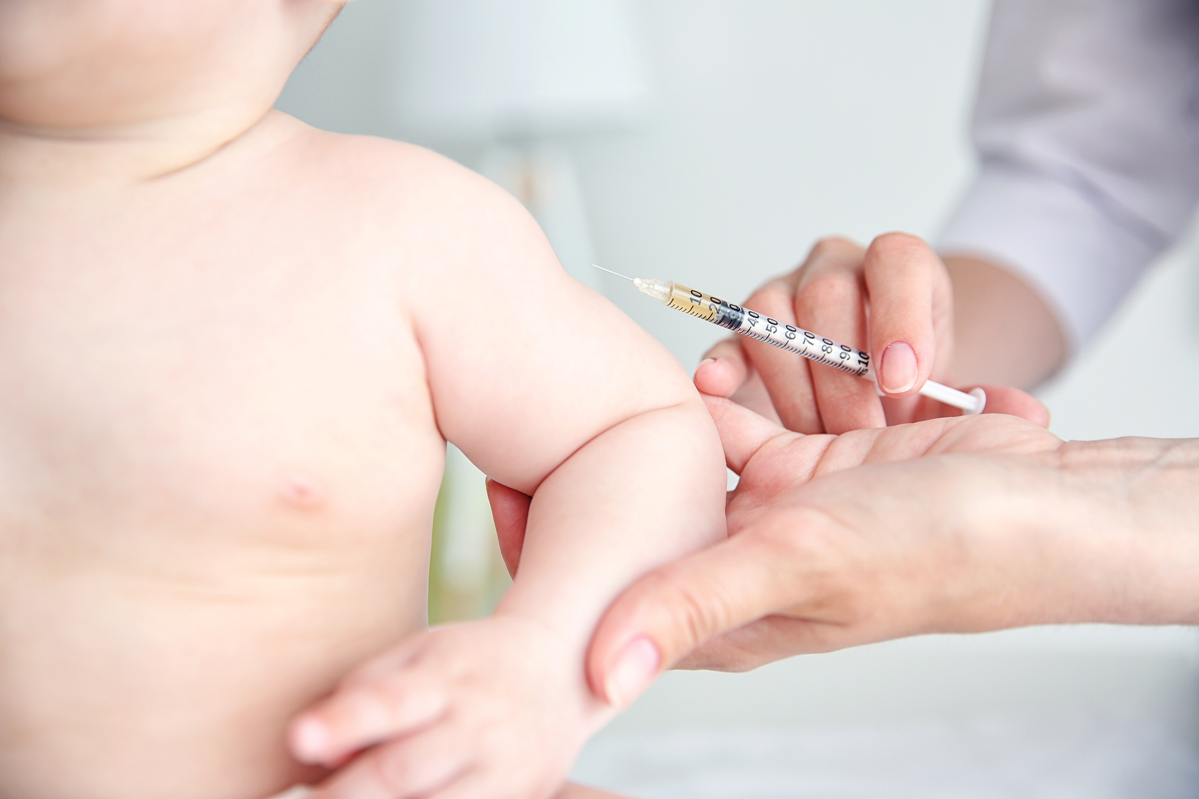 Professional Pediatrician Vaccinating Baby Close up